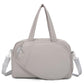 Grey waterproof duffel bag with top handles and side shoulder straps