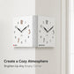 White dual-sided corner wall clock with black hands and colored here/elsewhere dots