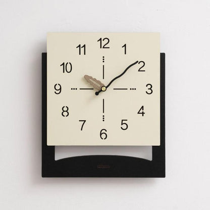 Cream white wall clock with minimalist black numbers and dark hanging base