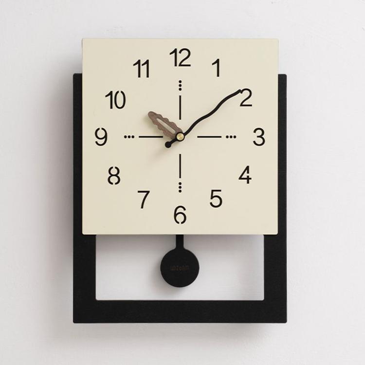 Cream white wall clock with minimalist dial, black hands, and round black pull ring