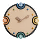 Close-up modern wall clock: black rim, cream dial, colorful numbers, metal hands