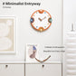 Modern orange-rim wall clock on a wall, cream dial with colorful numbers and metal hands