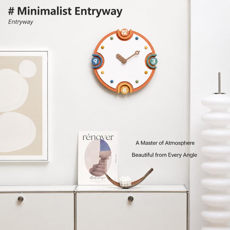 Modern orange-rim wall clock on a wall, cream dial with colorful numbers and metal hands