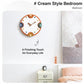 Modern orange-rim wall clock with cream dial and colorful number markers above bedside