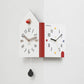 White double-faced corner wall clock, house shape with red knob and multicolor numeral blocks