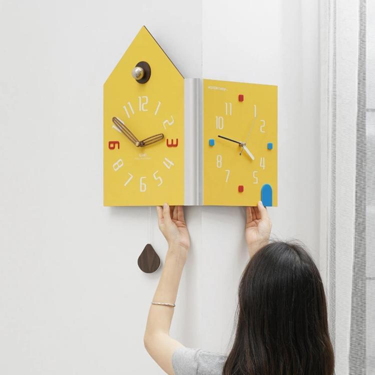 Yellow dual-face corner wall clock shown being mounted, house shape with knob and colored markers