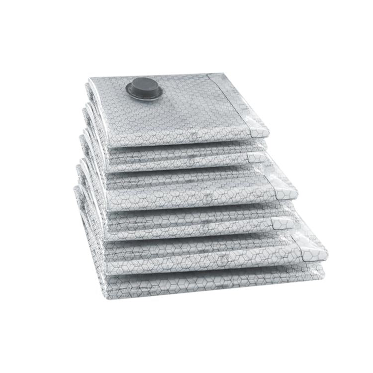 Folded clear vacuum compression bags with round valve cap, ready for clothing storage