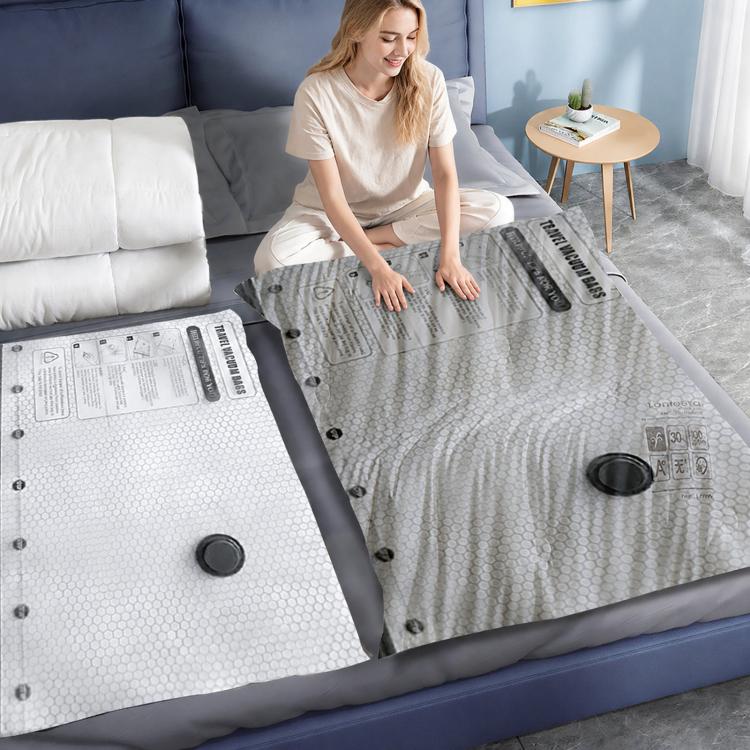 Person placing a large vacuum storage bag on a bed with round valve cap