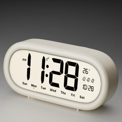 White digital alarm clock with large time, date, and temperature display icons