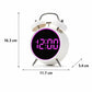 White twin bell digital alarm clock with purple glowing ring and LED time display