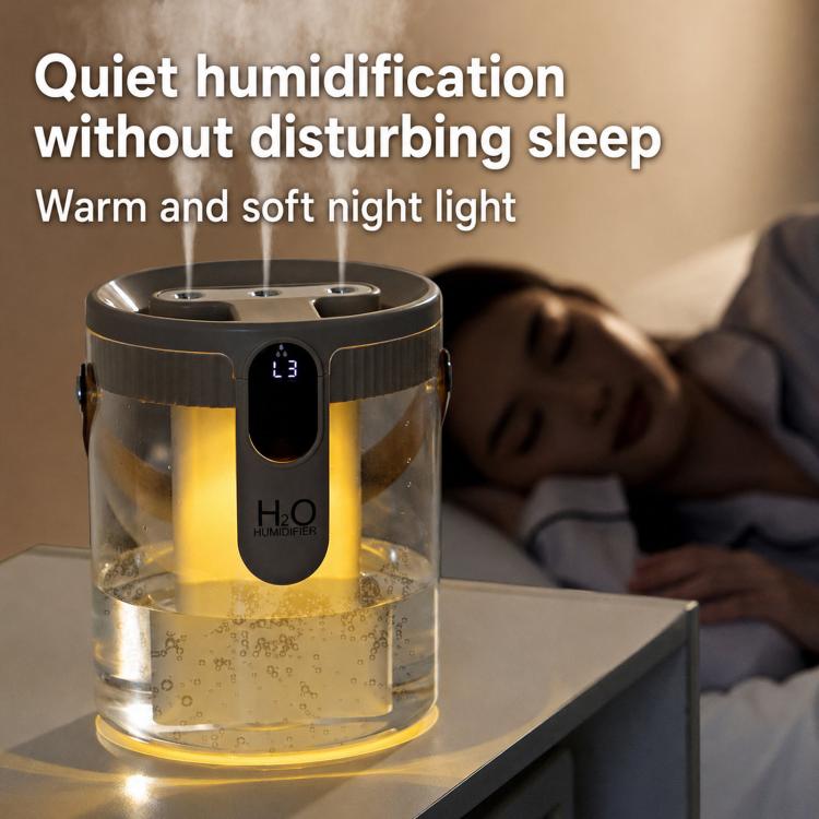 Black-tinted 1.5L humidifier releasing mist with warm ambient night light