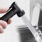 Handheld black toilet sprayer releasing a water stream into bowl