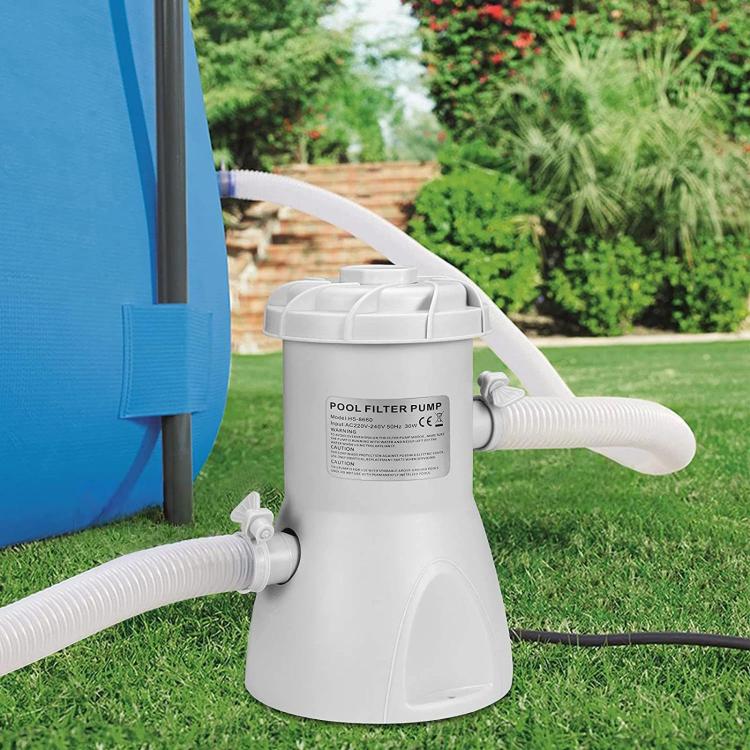 White pool filter pump with connected hoses and outlet spout for in-ground swimming pools