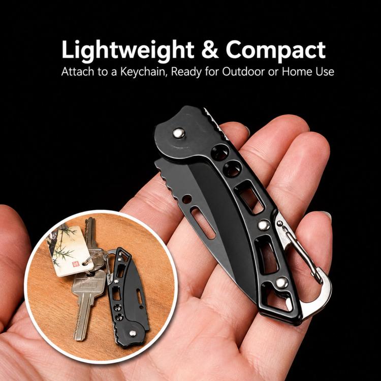 Black lightweight folding knife with carabiner, held in hand