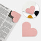 Pink heart-shaped bookmark corner clip with stitched edges, faux leather corner protector