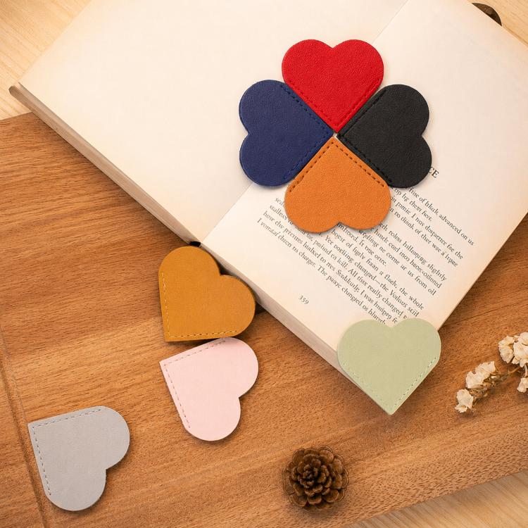 Mixed heart-shaped bookmark corner clips on an open book, faux leather corner protectors