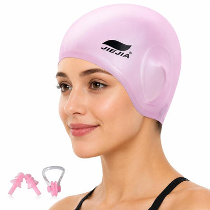 Pink silicone swimming cap with ear-protecting pockets and included earplugs and nose clip