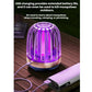Mosquito killer lamp with USB charging cable and purple LED glow on wooden surface