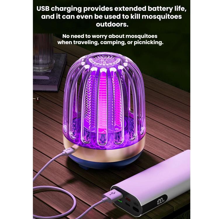 Mosquito killer lamp with USB charging cable and purple LED glow on wooden surface
