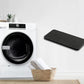 Black rectangular foam dryer filter lying near a tumble dryer