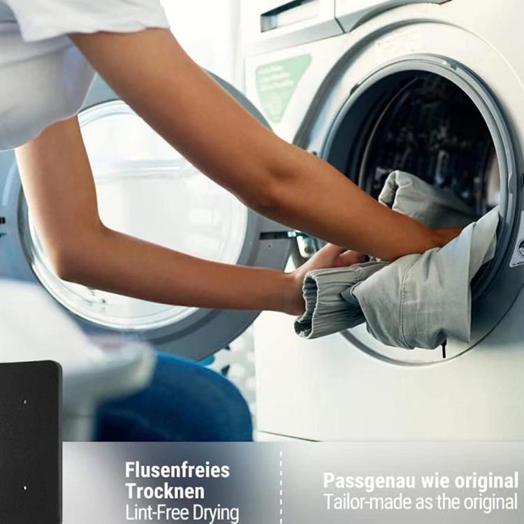 Black foam dryer filter beside a tumble dryer door