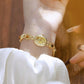 Gold oval dial bracelet watch with linked chain band, vintage analog quartz face