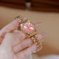 Two-tone analog wristwatches on hand: rose-gold tone and crystal-studded bezel