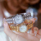 Two women’s analog wristwatches held in hand, silver and rose-gold tones with bracelets