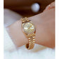 Women's gold-tone analog wristwatch with rhinestone bezel, date window, steel band