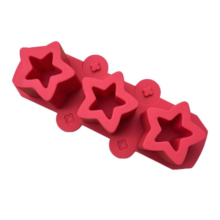 Red silicone squishy mold bar with three star cavities and small flower accents
