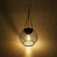 Warm-lit black metal mesh globe hanging lantern with hanging chain