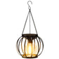 Hanging black metal lantern with vertical glass panels and warm bulb glow