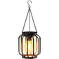 Hanging black metal lantern cage with warm light inside