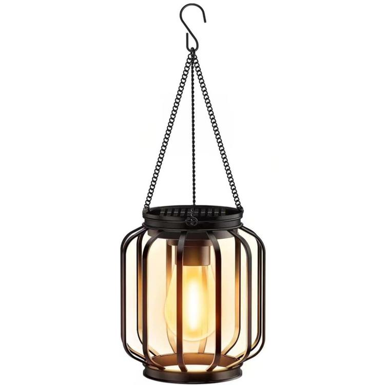 Hanging black metal lantern cage with warm light inside