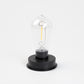 Clear bulb lamp inside black base for hanging solar lantern
