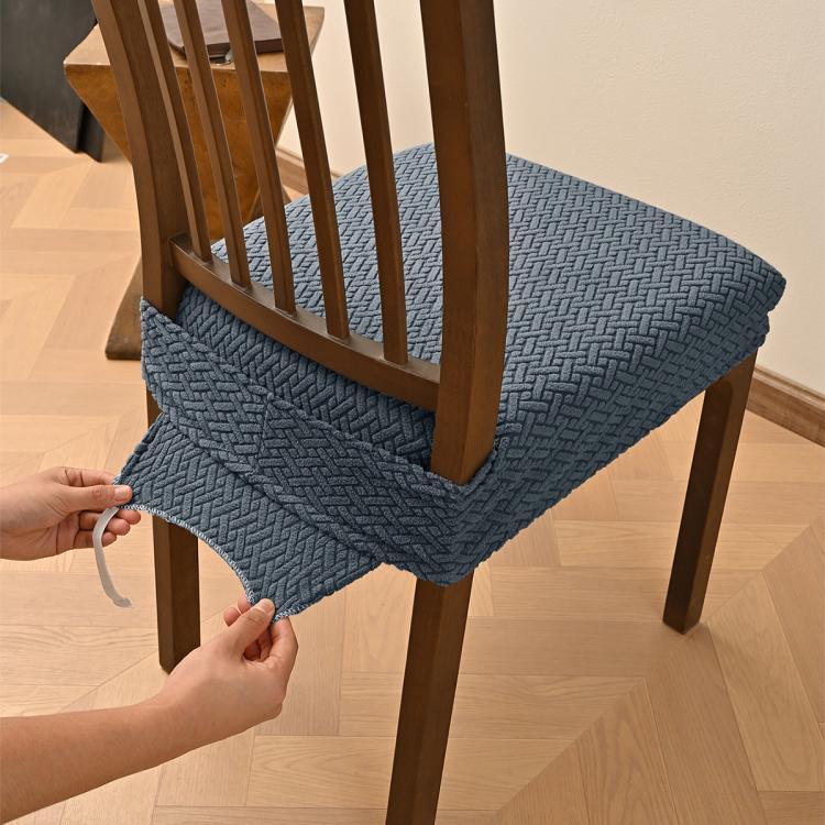 Dark gray textured dining chair seat cover with elastic hem and buckle tabs