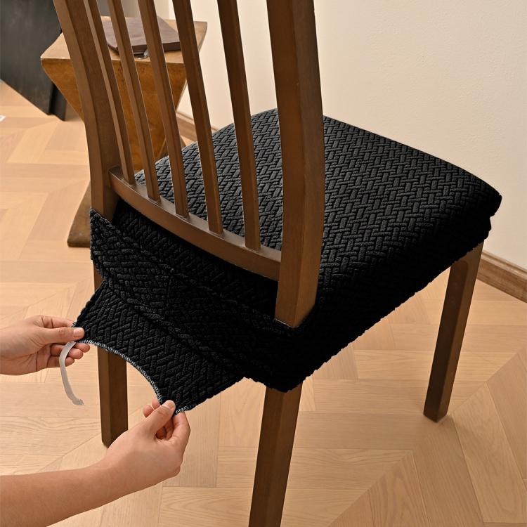 Black textured dining chair seat cover with elastic hem and buckle tabs