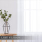 White sheer rod pocket curtain panel filtering daylight with smooth vertical drape