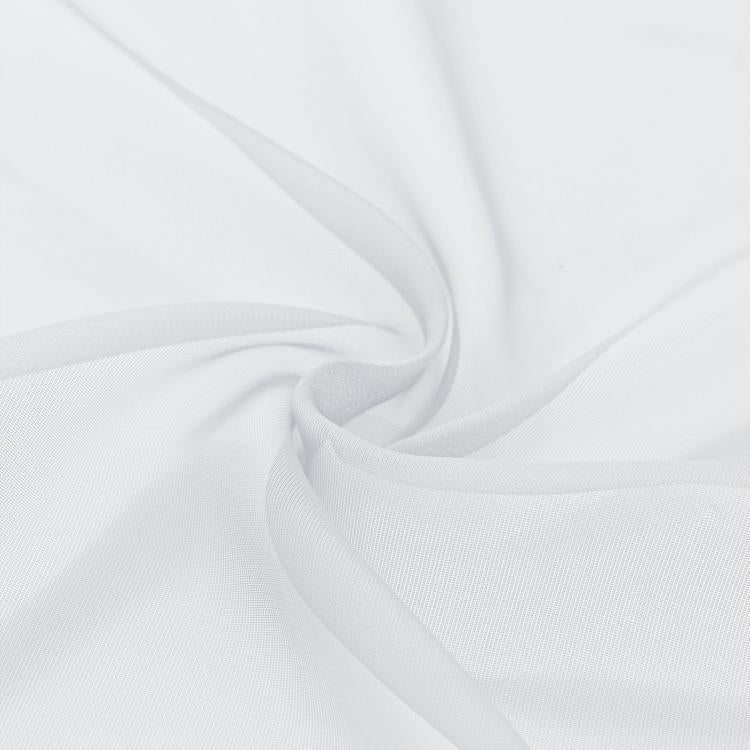 Close-up of white sheer voile fabric with soft woven texture and gentle drape