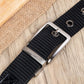 Men's nylon belt close-up with silver buckle and metal pin on black striped webbing