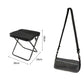 Black foldable crossbody bag-stool with padded seat and metal folding frame.
