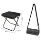 Black large foldable crossbody bag-stool with padded seat and folding metal legs.