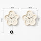 Cream flower wall clock with black hands; size shown as 39 cm by 65 cm