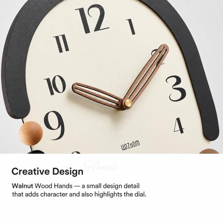 Retro oval wall clock close-up with black frame, cream dial, wooden hands, gold second hand.