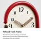Retro oval wall clock with red frame, cream dial, striped hands and gold minute marks.