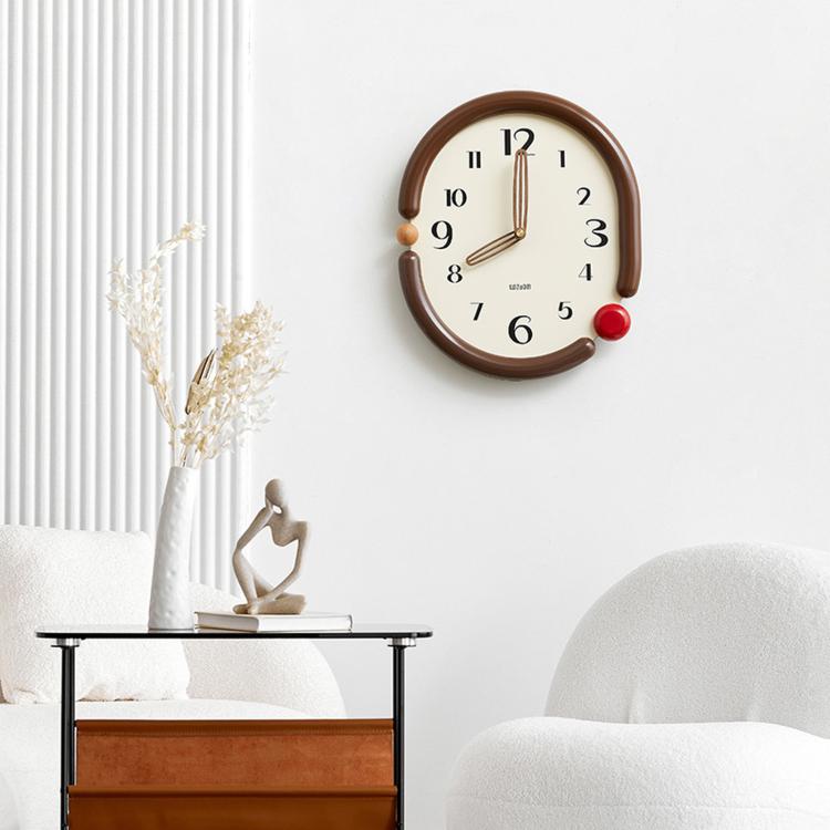 Retro oval wall clock with dark brown frame, cream dial, gold hands, red side knob.