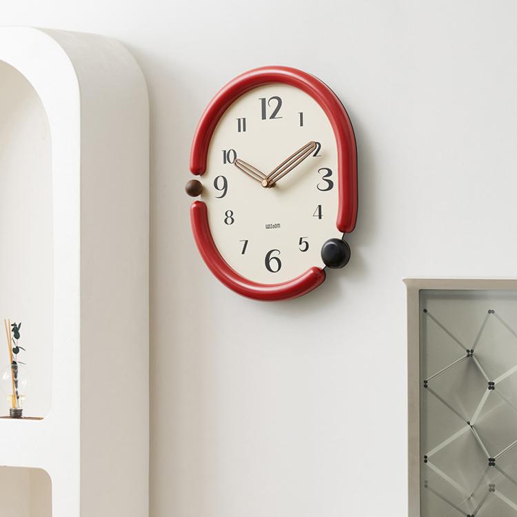 Retro oval wall clock with red frame, white dial, and metal hour and minute hands