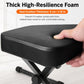 Thick black padded piano stool seat with textured surface and X-frame legs