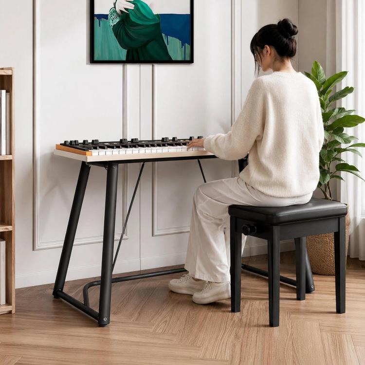 Black U-shaped metal electronic piano stand in use with keyboard