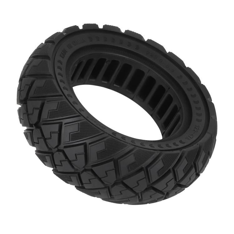Black solid scooter tire with thick tread lugs and diamond pattern, front view.